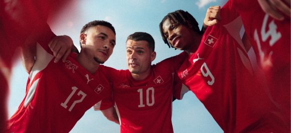 The picture shows Swiss national football players in a team huddle.
