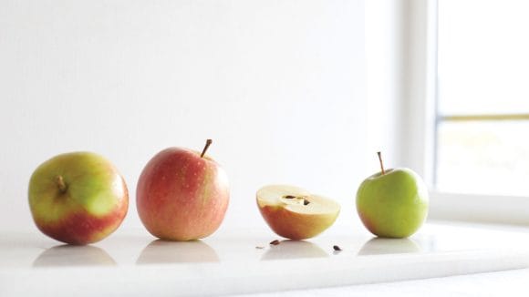 Various apples on a sideboard