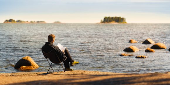 Man reading book on beach