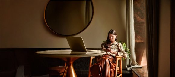 Woman with laptop and phone