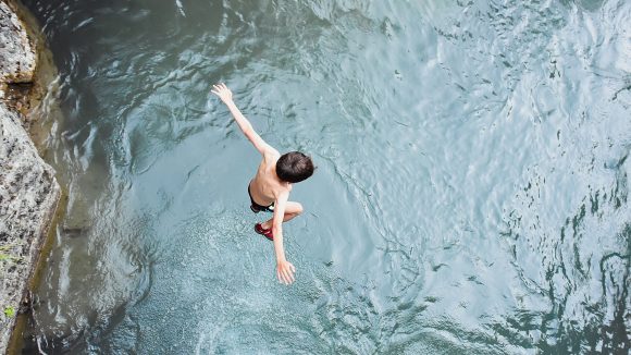Boy jumping in water