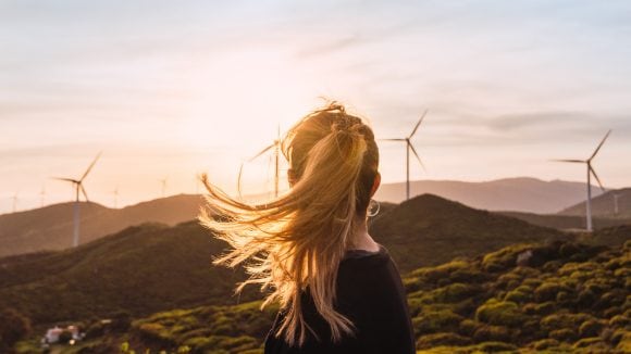woman in front of the windmill farm