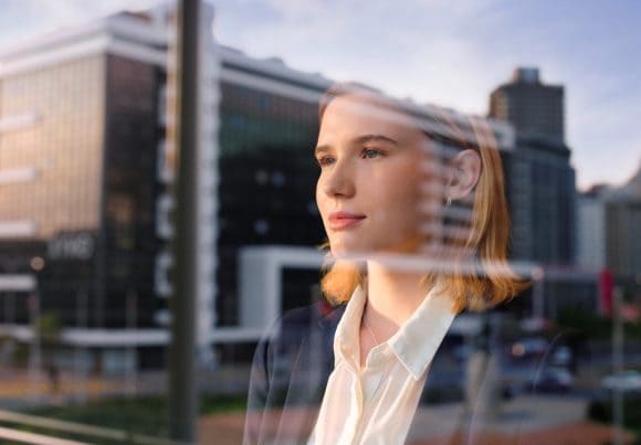 Businesswoman looking through window