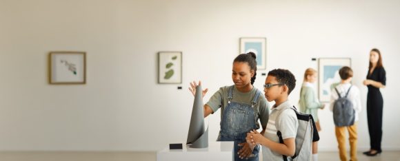 School age children looking at a sculpture at a museum