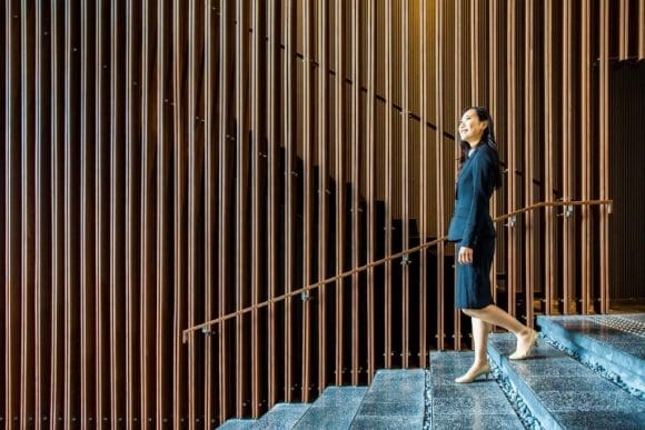 Asian lady walking down the stairs