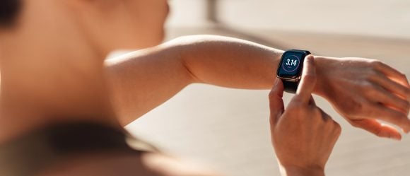 Woman checking fitness progress on smartwatch