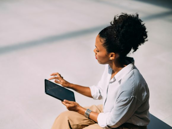 A businesswoman outdoors with a smartphone