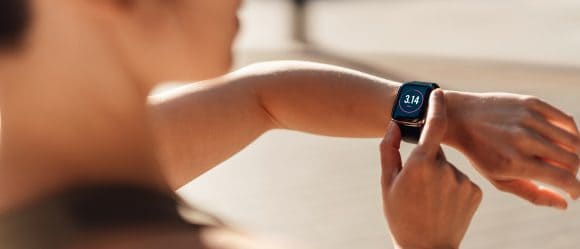 Woman checking fitness progress on smartwatch