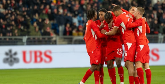 Swiss national football players celebrate a goal during a match
