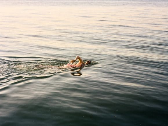 Woman swimming in open water.
