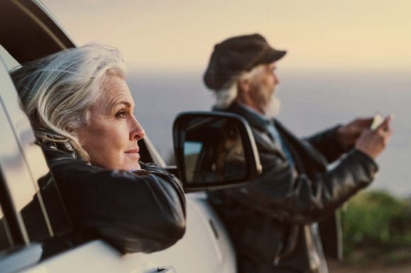 The eldery couple admiring beautiful landscape during holiday trip.