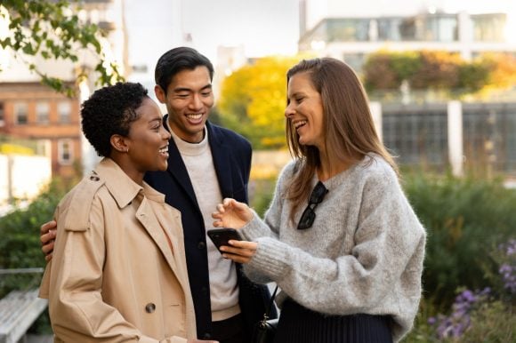 Trois amis rient ensemble.