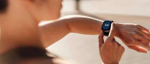 Woman checking fitness progress on smartwatch