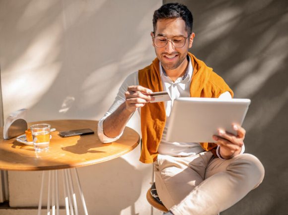Transparent hourglass with red sand against a light background, symbolizing the passing of time and the importance of early planning.