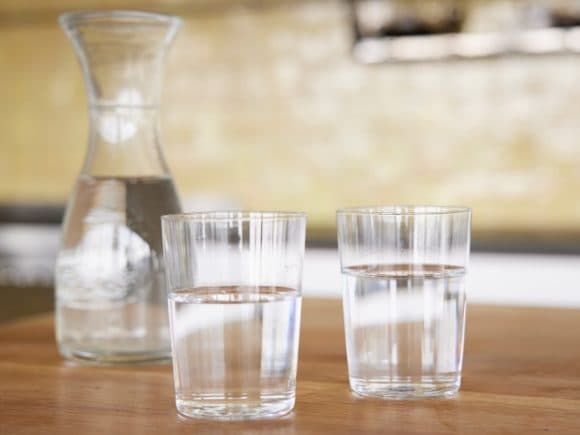 Table with a water carafe and two glasses of water