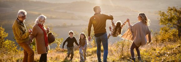 I nonni guardano la famiglia della figlia con due bambini durante un’escursione in montagna.