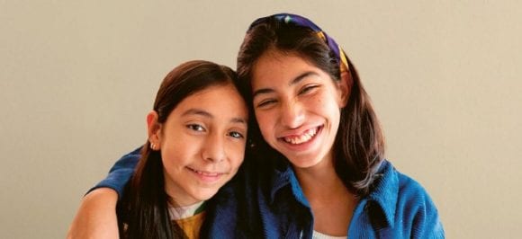 Two children are looking contentedly into the camera as they are being helped. The campaign text is also shown: Not all fears are visible from the outside.
