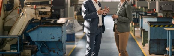 Colleagues discussing in a factory