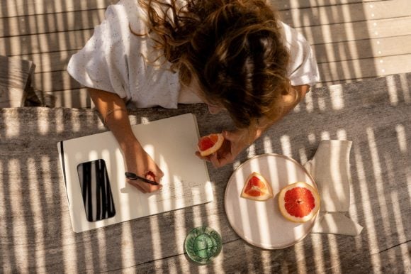 Woman writing in notebook