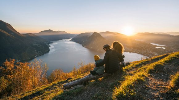 Family on mountain top overlooking Lake Lugano