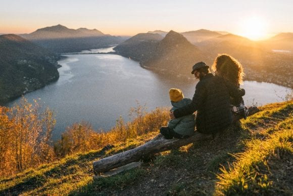 Family on mountain top overlooking Lake Lugano