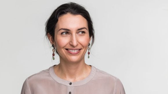 Smiling young woman looking sideways.