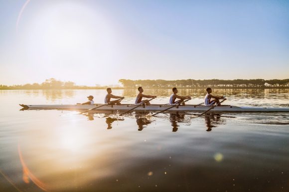 Rowing team training on lake