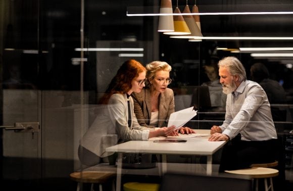 Business people discussing in office at night