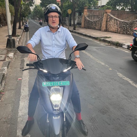 UBS employee riding an e-scooter outside