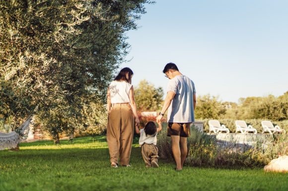 Parents holding hands with daughter