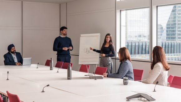 Employees giving presentation to colleagues
