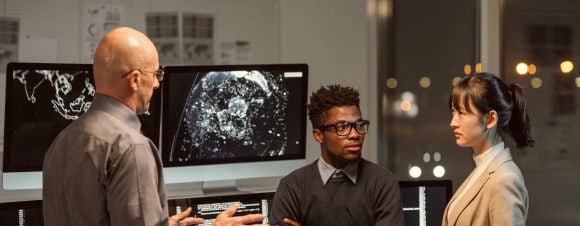 Three people are discussing