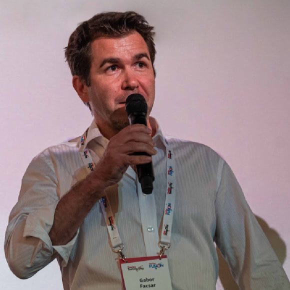 Gabor speaking into a microphone