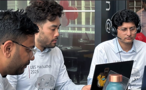 A group of men looking at a computer