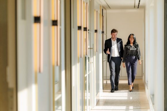 Employees having conversation in corridor at UBS Paris