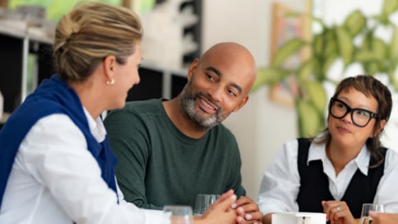 Colleagues sitting on a meeting table