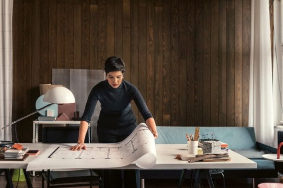 Architect with plan in studio