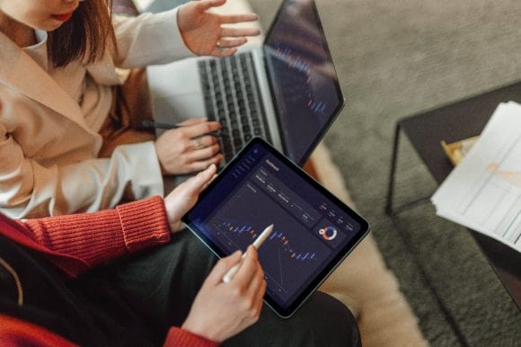 Image of two people looking at the graph on the tablet