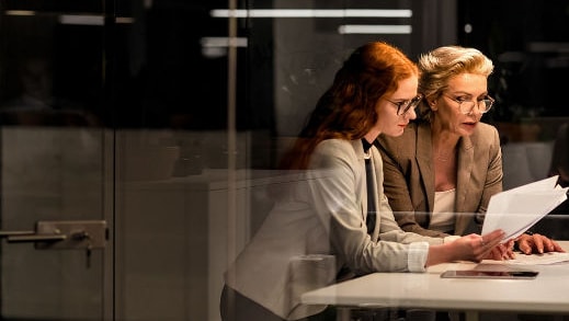 three people chatting and walking through office