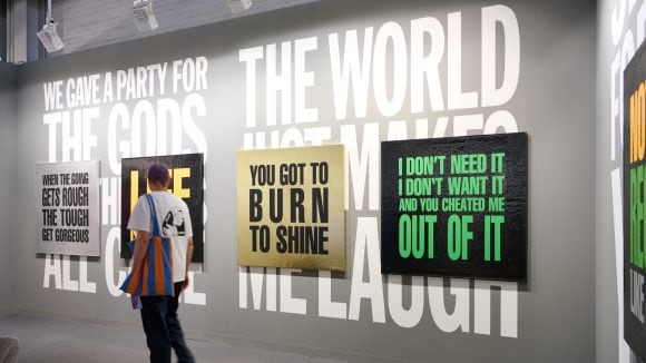 A person looking at a wall with words on it