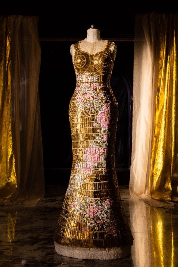 A mannequin wearing golden artistic dress