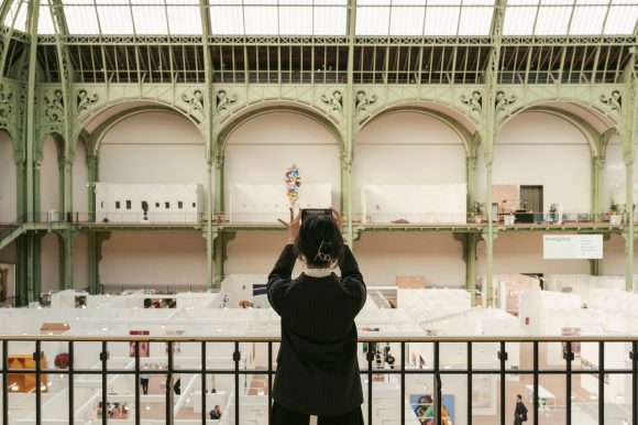 A lady clicking photo with her phone