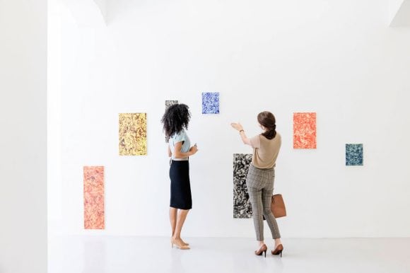 Two women looking at an art
