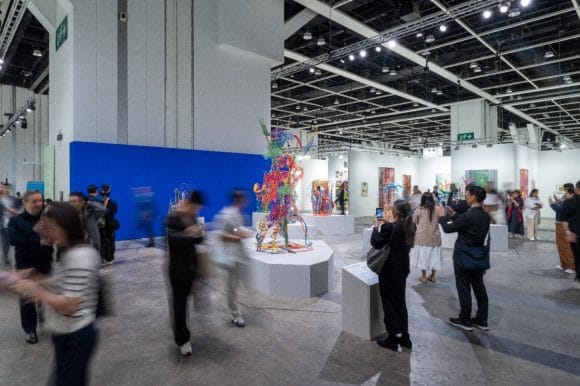 Visitor viewing colorful sculpture