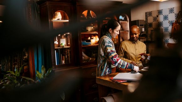 Shoemaker discussing with client at workshop