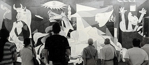 Visitors view Pablo Picasso's world famous painting Guernica