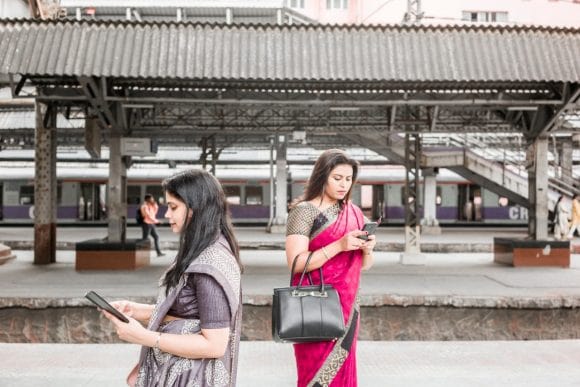 two women standing at railway platform