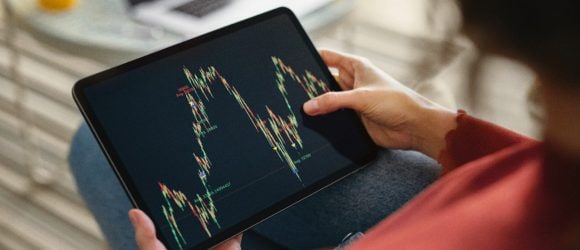 Woman analyzing chart on digital tablet