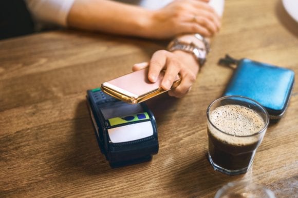 Woman making contactless payment