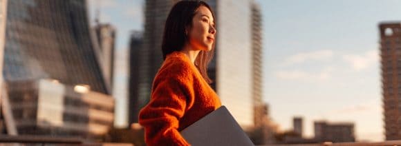 Businesswoman with laptop against London financial district